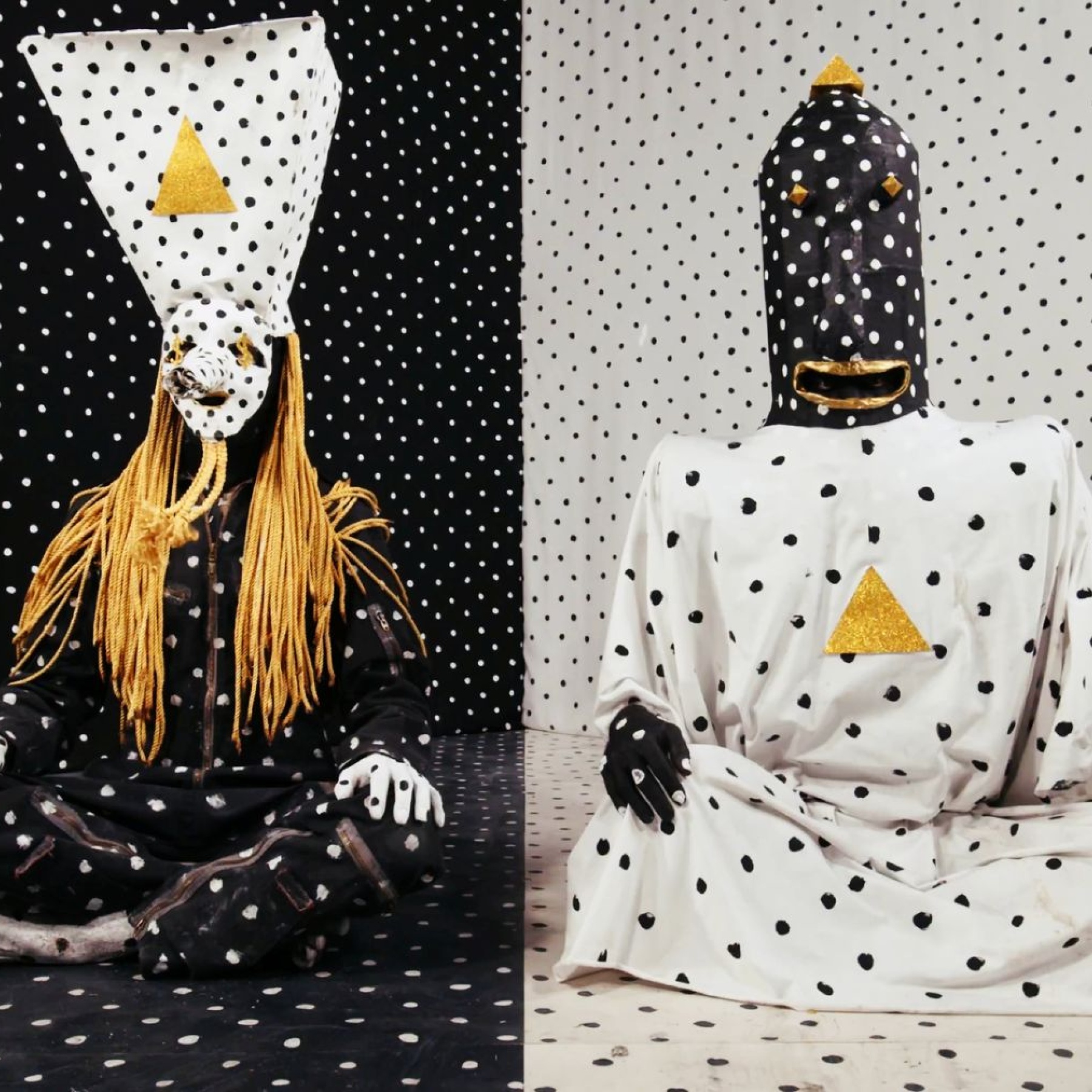Two people in a polkadot room wearing polkadot clothes