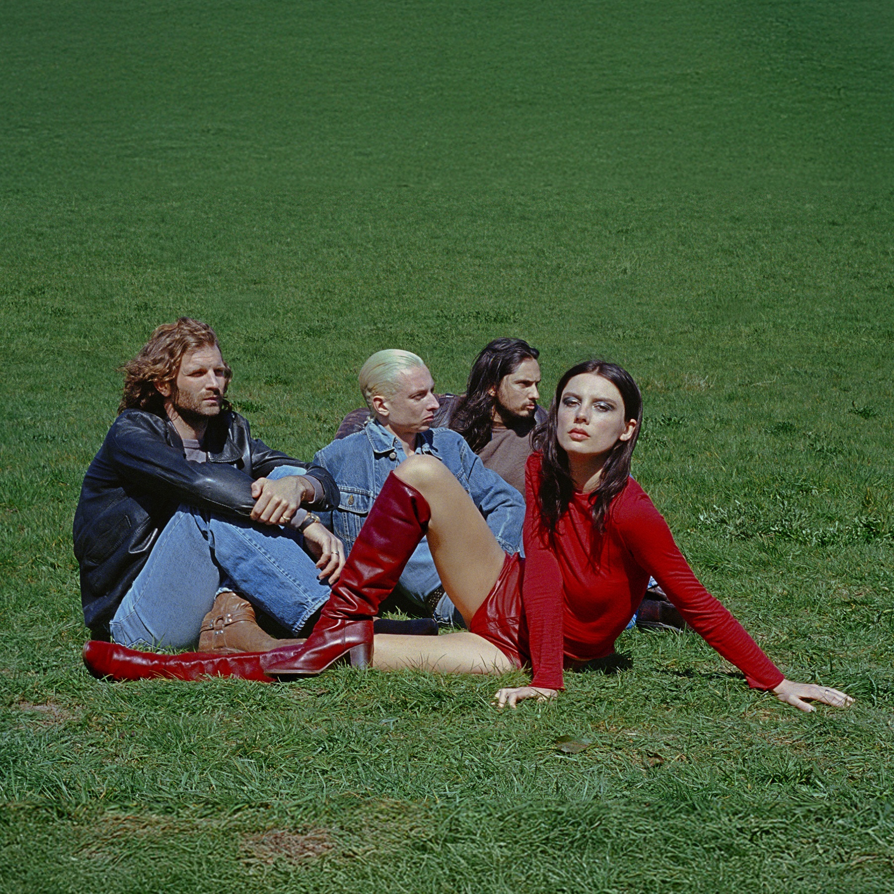 Band, group of 4 people sitting in the grass