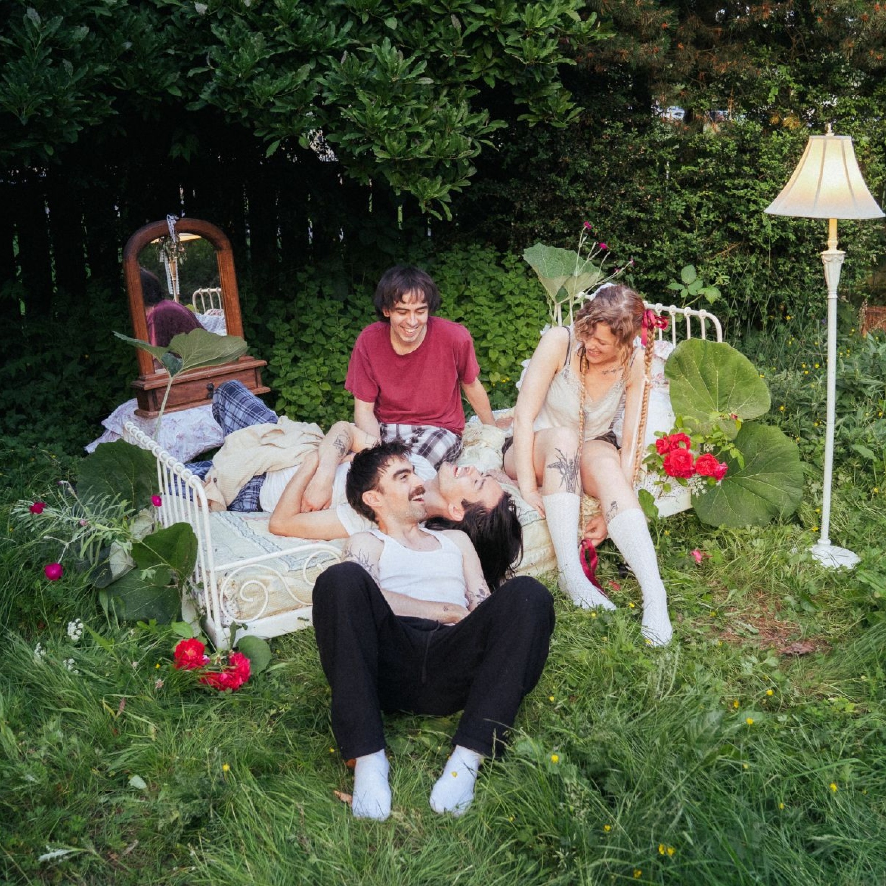 People laughing on a bed in a garden