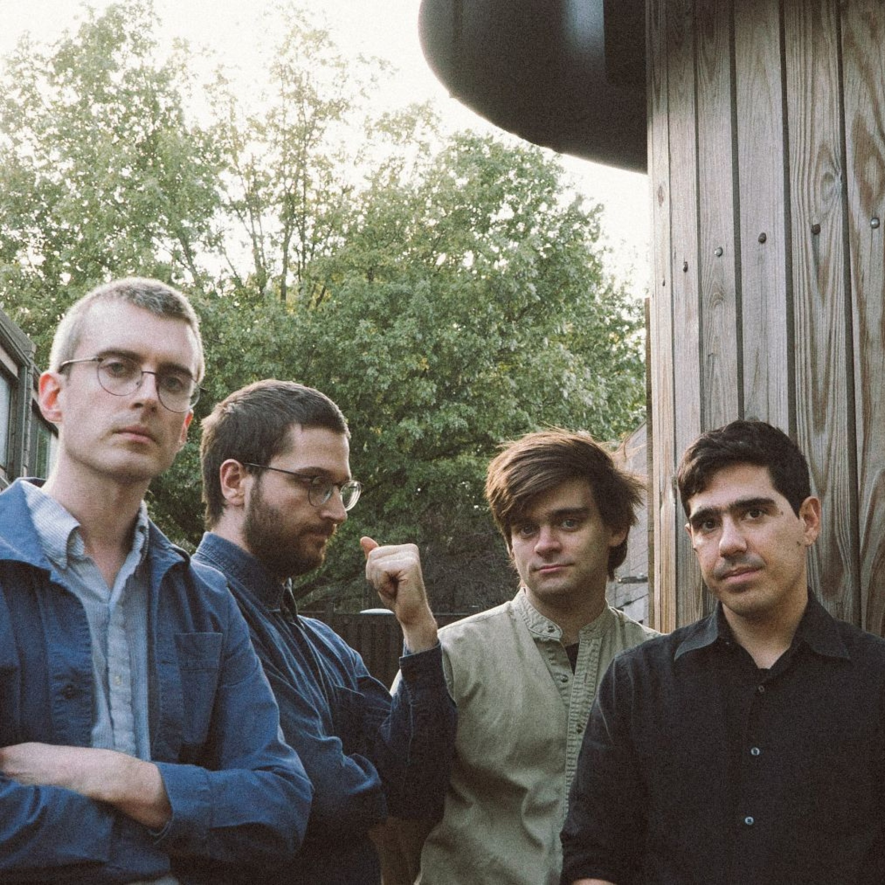 Four men standing in a garden
