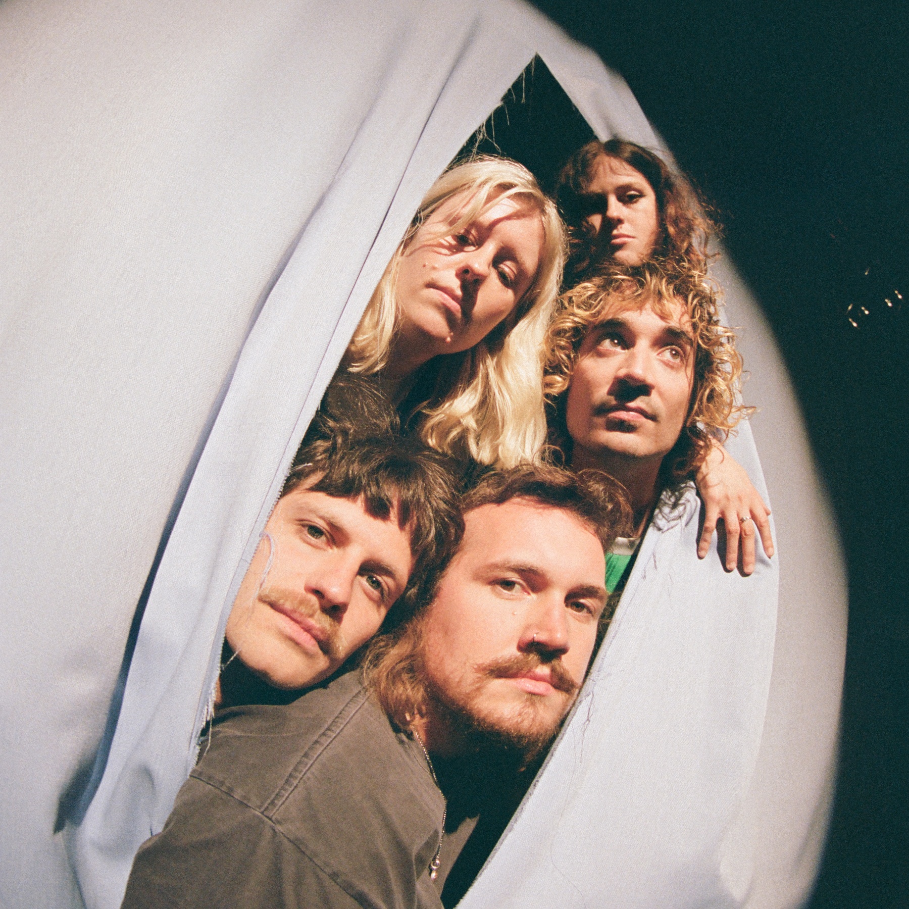 Five heads out of a curtain
