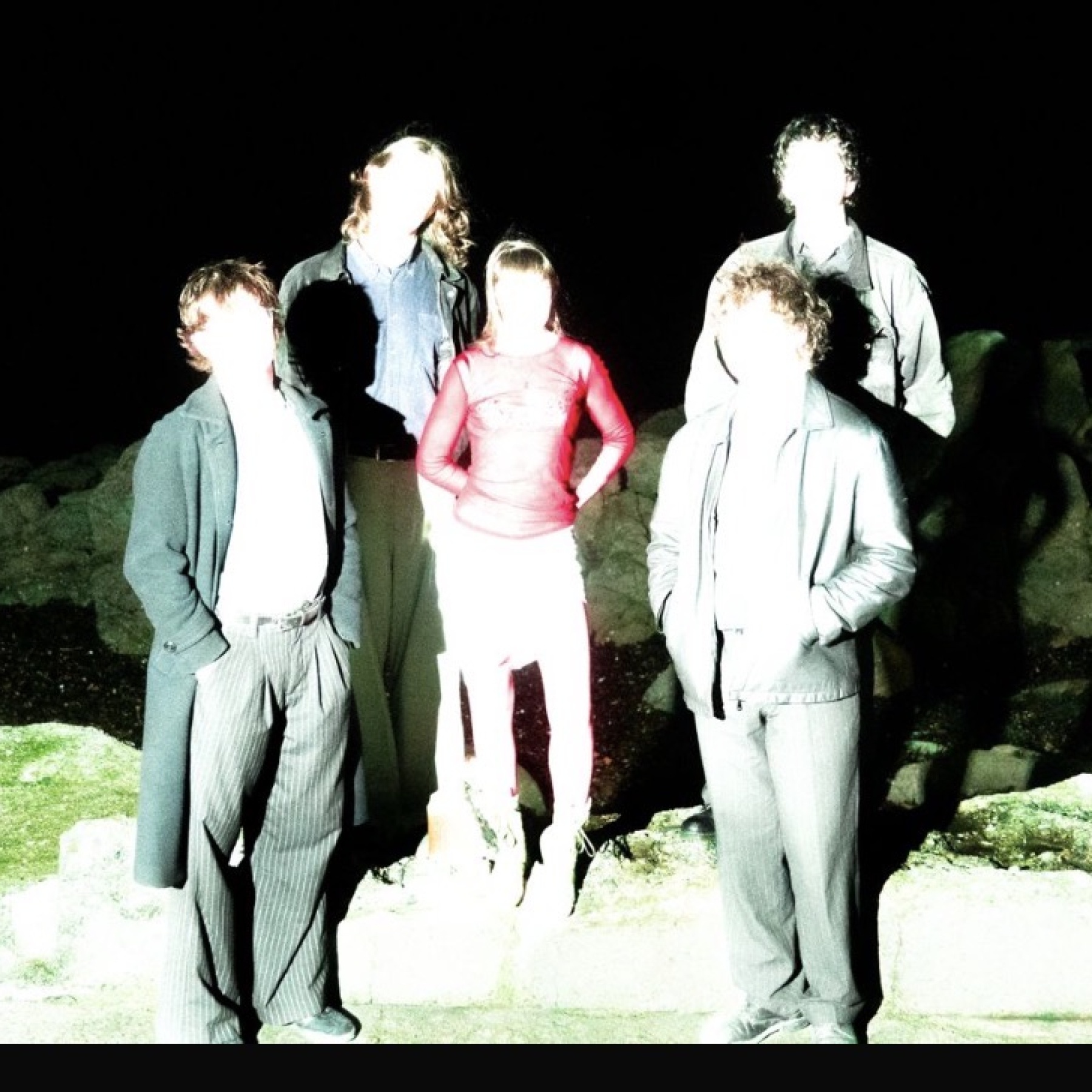 Five people standing in a field
