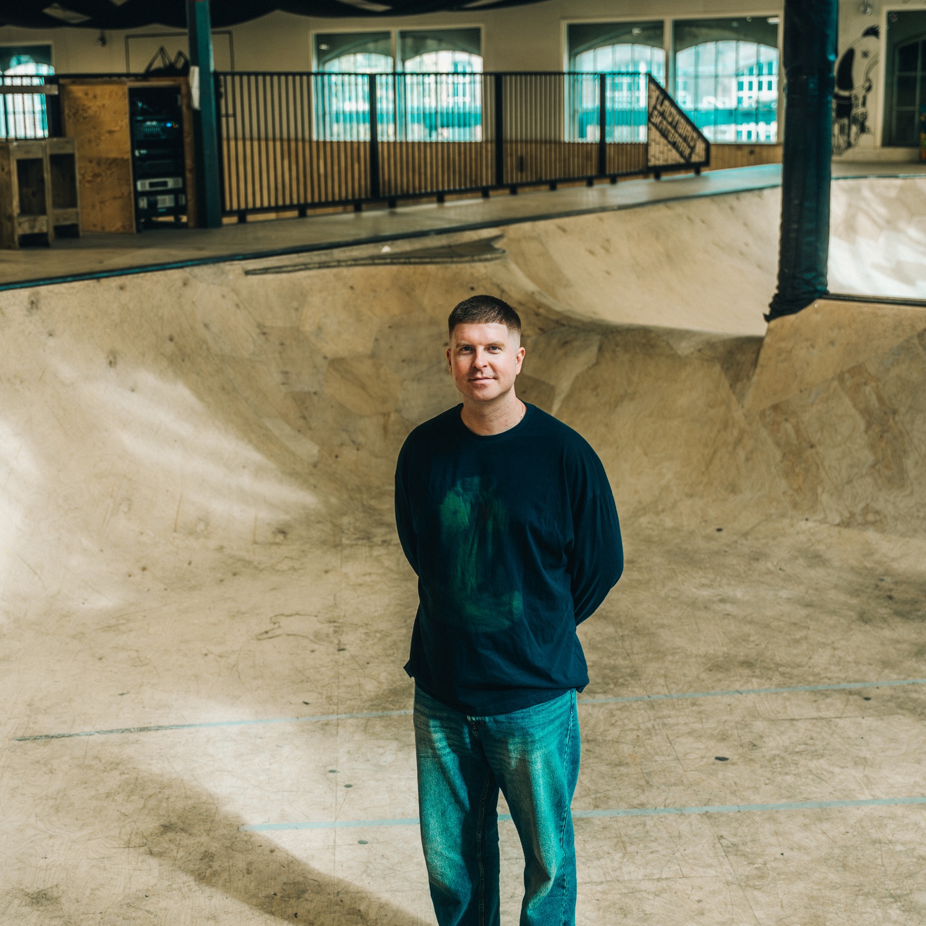 Man standing in empty skatepark