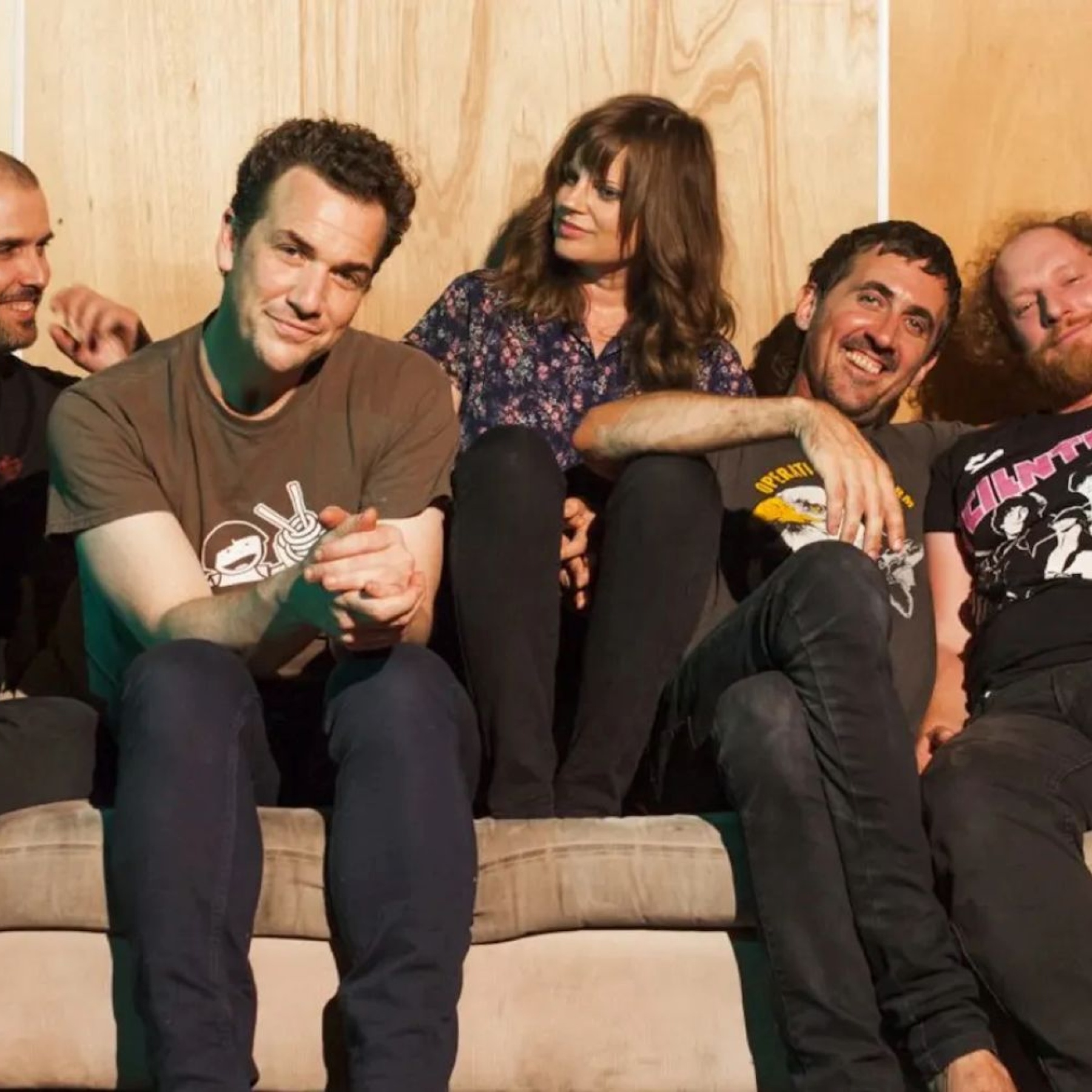 Five people sitting on a couch
