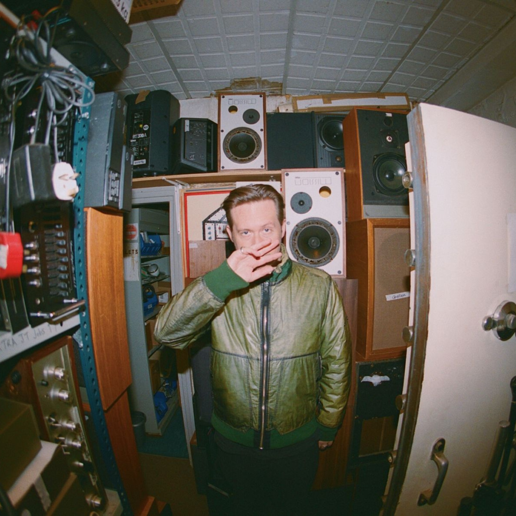 Man standing in a storage room with speakers