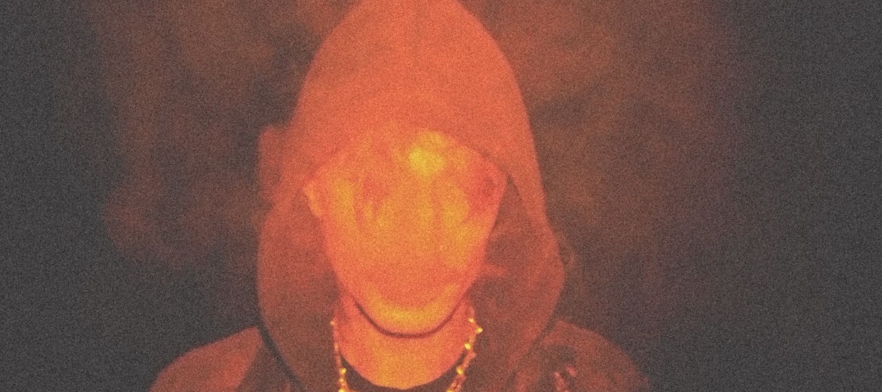 Man with hood smoking