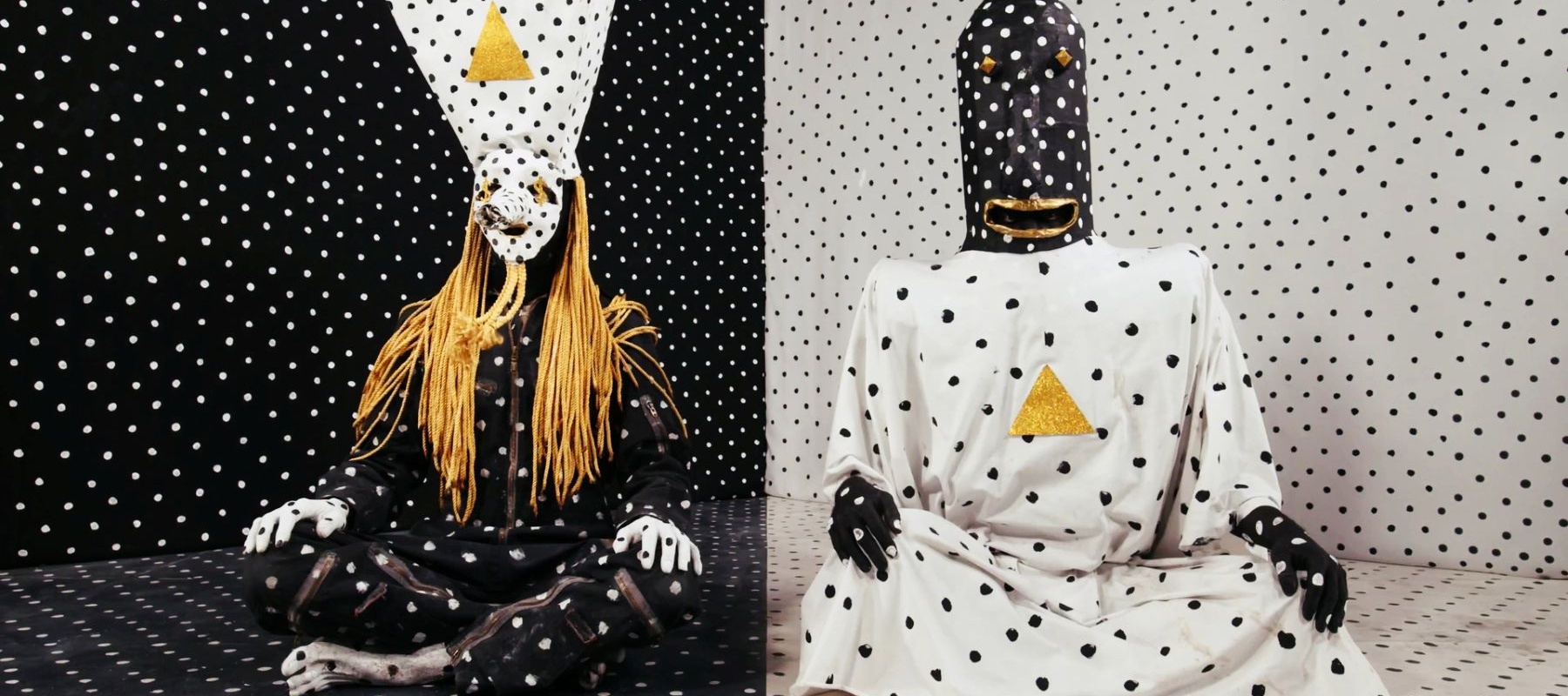 Two people in a polkadot room wearing polkadot clothes