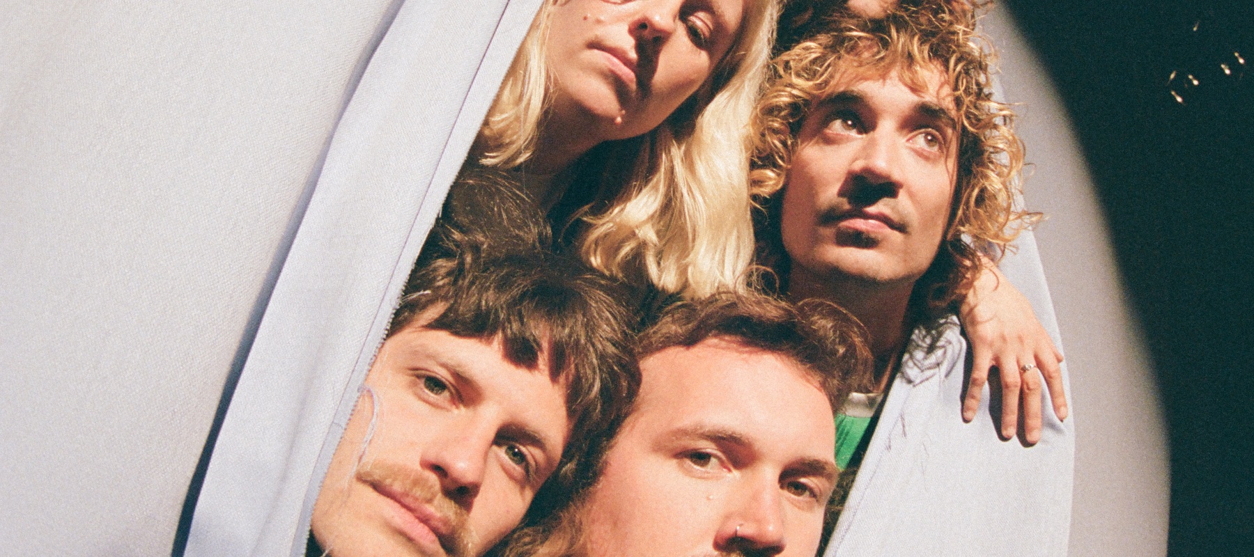 Five heads out of a curtain