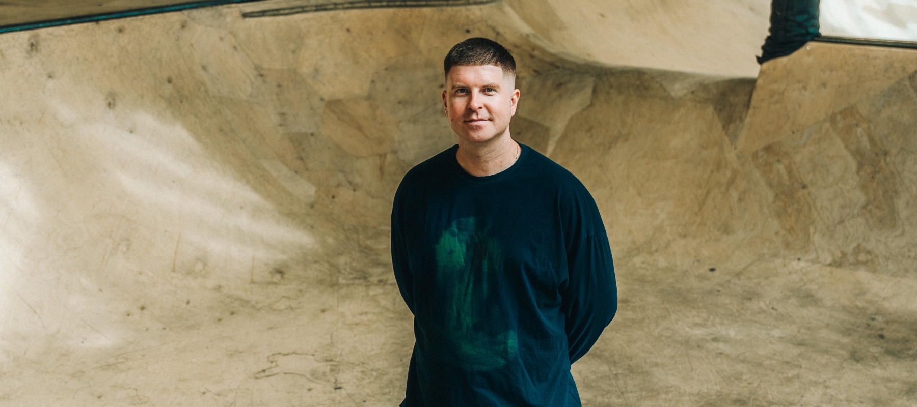 Man standing in empty skatepark