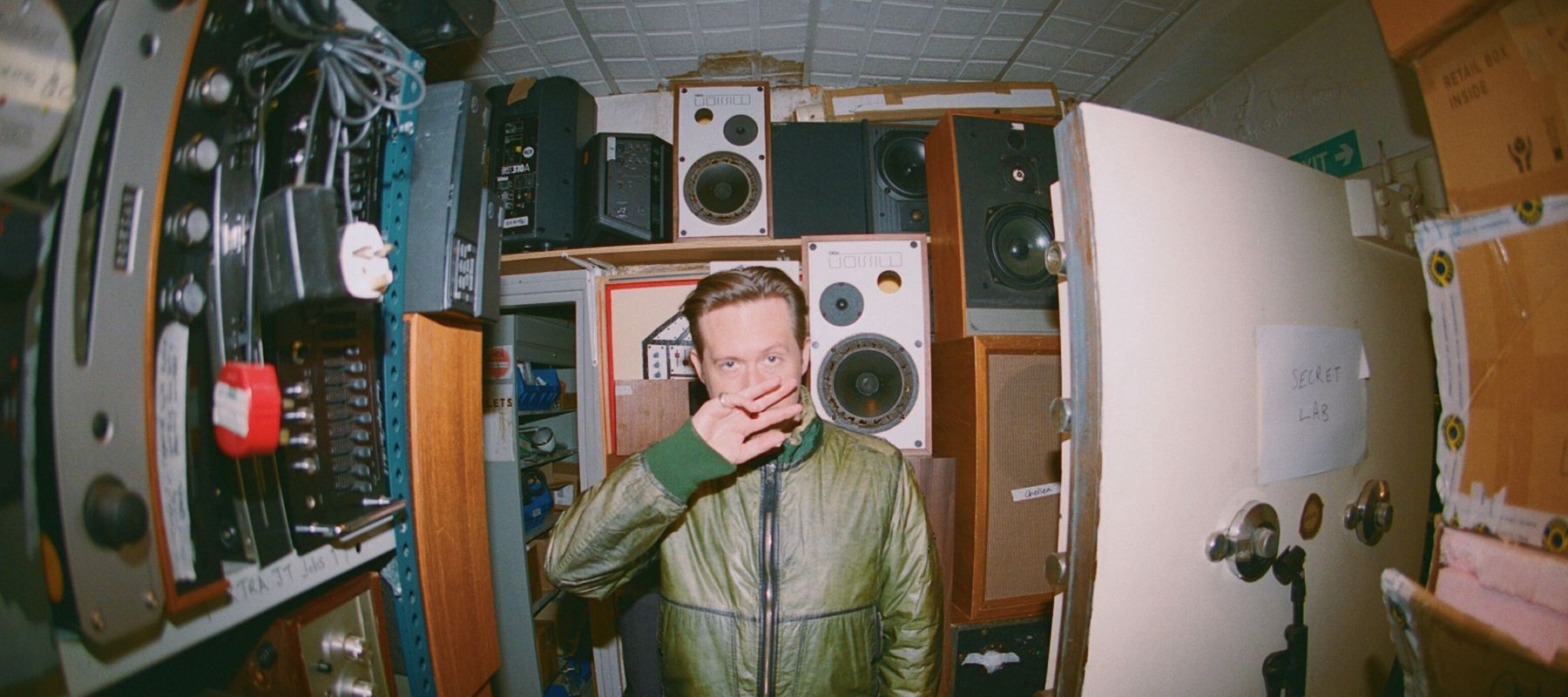 Man standing in a storage room with speakers