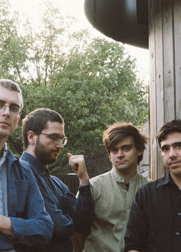 Four men standing in a garden
