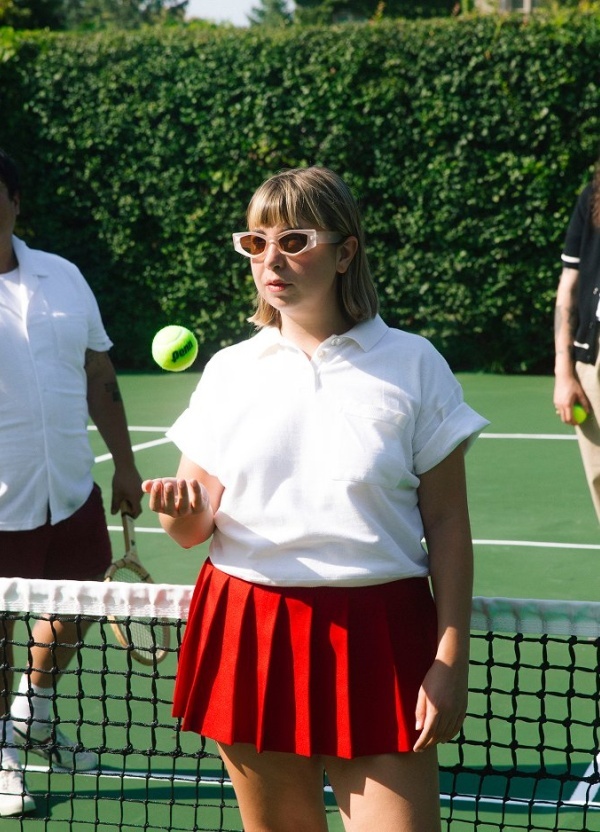 Three people on a tennis court